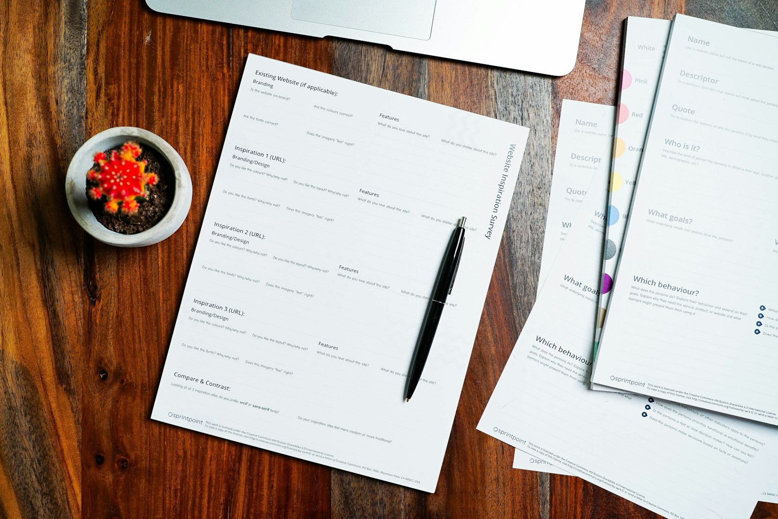Papers and a pen on a wooden table